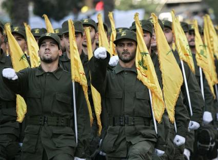 Хезболла
Members of the Hezbollah guerilla group hold yellow flags of the Hezbollah as they parade during the annual rally to mark Al-Quds Day, Jerusalem Day, in the southern suburbs of Beirut, Lebanon, Friday, Oct. 28, 2005.  Sheik Hassan Nasrallah, leader of Lebanon\\\'s Hezbollah guerrillas,  pledged Friday to support  Syria, and also lashed out at U.N. efforts aimed at disarming his anti-Israel guerrillas, saying the international community aims to serve the interests of America and Israel. (AP Photo/Hussein Malla)