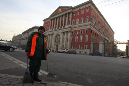 МОСКВА. Мэрия. Тверская улица. Гастарбайтер убирает улицу напротив здания московской мэрии.