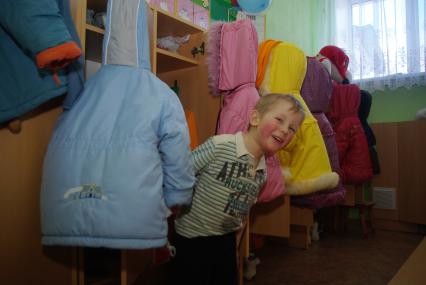 Дети в раздевалке детского сада переодеваются после прогулки на свежем воздухе, Саратов, 3 февраля 2011 года. Дети, детсад, детский сад, прогулка, одежда, зима, группа, куртка, раздевалка, шкафчики. детская мебель, детская одежда.