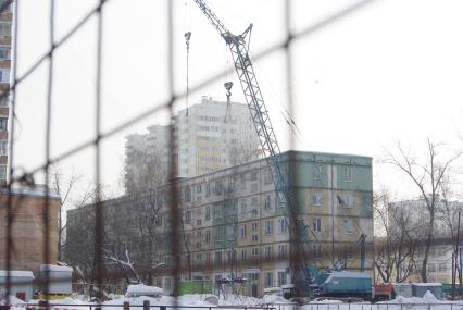 На месте снесенного дома возводят новый, на заднем плане хрущевка и новые дома, Москва, 17 февраля 2011 года, метро Кузьминки. Снос домов, новое жилье, хрущевка, строительство, ипотека, затройка города