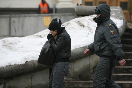 Милиционер у вокзала ведет двух нерусских нелегалов, Москва, 25 февраля 2011 года.