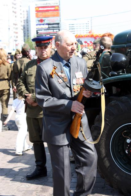 Москва 09 мая 2010 год. Празднование 9 мая. День победы. Ветеран держит в руках  ППШ.