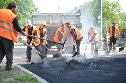 Гастарбайтеры кладут асфальт на пешеходную дорожку, Москва, 21 мая 2011 года