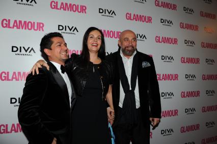 Церемония вручения премии ЖЕНЩИНА ГОДА ЖУРНАЛА GLAMOUR 2011. На снимке: продюсер Алексей Боков, телеведущая Екатерина Андреева и художник Павел Каплевич (справа). 17 ноября 2011 года.