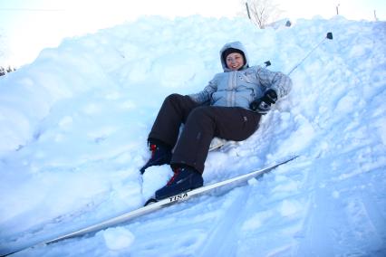 Девушка занимается лыжным спортом в деревне под Нижним Новгородом. Лежит с сугробе. 7 января 2011 года.