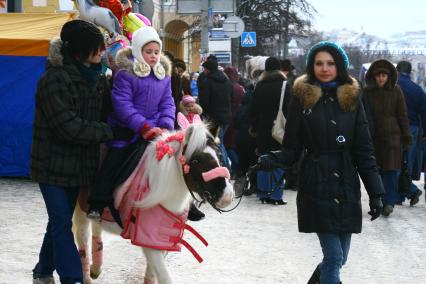 Девочку катают на маленькой лошадке, пони. 7 января 2010 года.