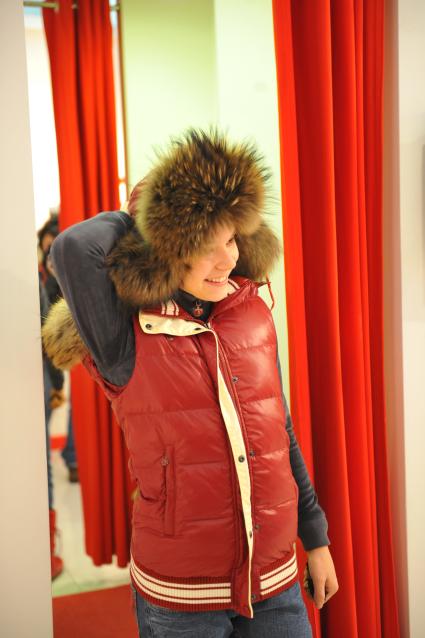 Магазин Bosco Sport в ГУМе. Экипировка российской фигуристки Аделины Сотниковой к зимним юношеским олимпийским играм. На снимке: Аделина Сотникова примеряет зимнюю шапку. 21 декабря  2011 года.