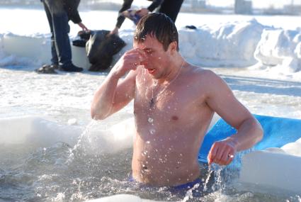 Крещение. Мужчина купается в ледяной проруби. Новосибирск. 19 января 2011 года.