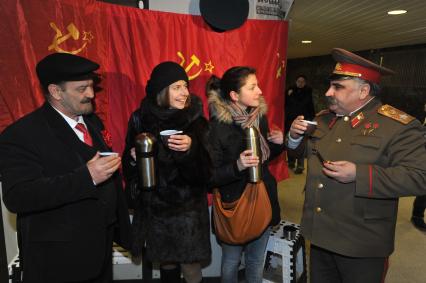 Подземный переход метро. Девушки угощают мужчин в образе В.И.Ленина и И.В.Сталина горячим чаем из термоса. 24 января 2012 года.