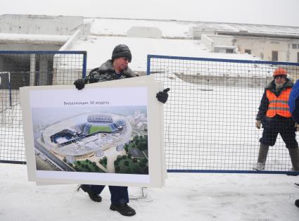 План реконструкции стадиона ДИНАМО. На снимке: мужчина несет стенд с надписью ВИЗУАЛИЗАЦИЯ 3D МОДЕЛЬ. 02 февраля 2012 года.