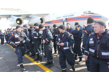 Сотрудники МЧС готовятся к перелету в Японию где произошло сильнейшее землетрясение и цунами. Спасатели стоят около самолета.