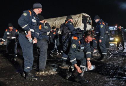 Спасатели отмывают обувь из бутылок с чистой питьевой водой.