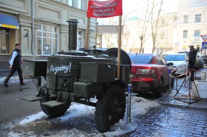 Вдоль дороги припаркован военный прицеп с надписью ЗА РОДИНУ.