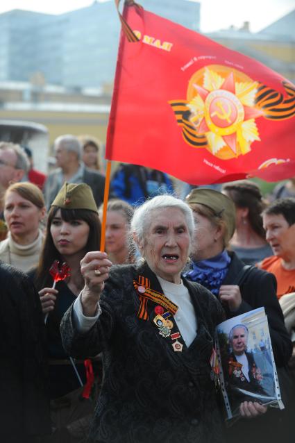 Ветераны во время празднования 67-й годовщины победы в Великой Отечественной войне. На снимке: ветеранка с красным флагом.