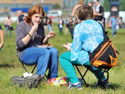 Аэродром `Тушино`. 15-й международный музыкальный фестиваль `Maxidrom`. Люди едят шашлык на траве.
