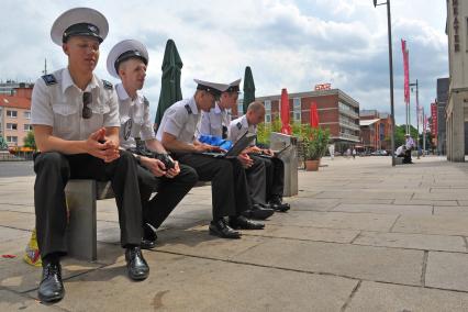 Порт города Бремерхафена. На снимке: российские курсанты сидят на пристане.