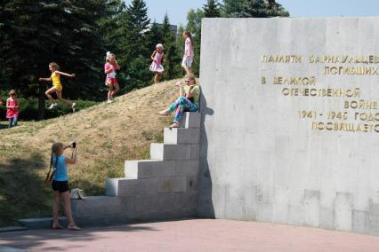 Мемориал памяти павших в ВОВ в Барнауле. Дети фотографируются на фоне мемориала.