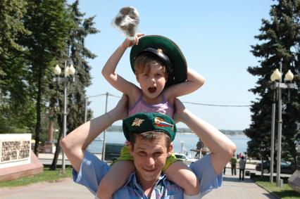 Празднование дня пограничника в Волгограде. На снимке: Мужчина держит на плечах ребенка в фуражке пограничника.