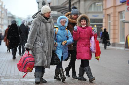 Женщина с детьми школьного возраста.