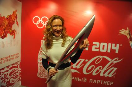 Центр фотографии имени братьев Люмьер. Выставка `Coca-Cola. Пронеси Олимпийский Огонь. Вливайся!`. Открытие. На снимке: 3-х кратная олимпийская чемпионка по синхронному плаванию Мария Киселева с факелом Олимпийских Игр 2014 в Сочи.