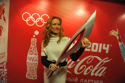 Центр фотографии имени братьев Люмьер. Выставка `Coca-Cola. Пронеси Олимпийский Огонь. Вливайся!`. Открытие. На снимке: 3-х кратная олимпийская чемпионка по синхронному плаванию Мария Киселева с факелом Олимпийских Игр 2014 в Сочи.