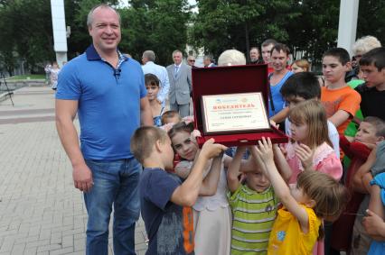 Белгород. Соборная площадь. Церемония вручения многодетным семьям премии `Родительский рекорд`. На снимке: президент фонда `Поколение` Андрей Скоч вручил семье Соркоиных номинацию `Открытое сердце`.