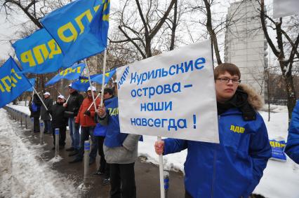 Митинг Московского отделения ЛДПР у посольства Японии. На снимке: участник митинга с плакатом `Курильские острова - наши навсегда!`