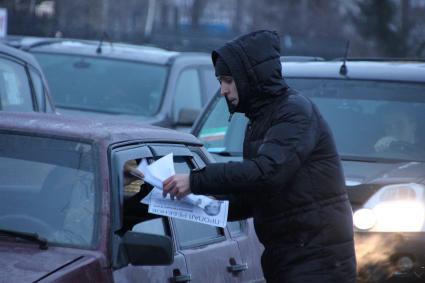 Волонтер раздает объявления по поиску пропавшего ребенка Василисы Галициной.