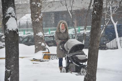 Девушка гуляет с ребенком в Петровском парке.