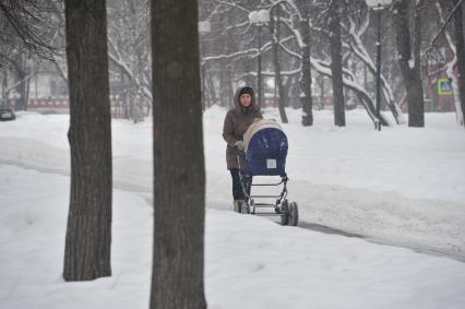 Девушка гуляет с ребенком в Петровском парке.