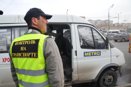 Сотрудники Госавтоинспекции совместно с ФМС провели рейд по выявлению незаконных маршрутных такси. На снимке: мужчина в жилете с надписью `Контроль на транспорте`