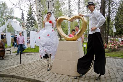 Молодожены Екатерина и Максим Березины из Екатеринбурга на церемонии бракосочетания, под свадебные наряды ребята надели `джоли-джампинг` - ходули с пружинами.