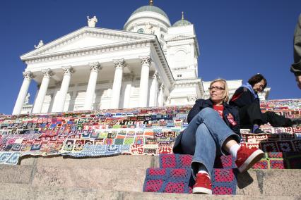 Рукодельная акция в Хельсинки, по созданию самого большого в мире лоскутного вязаного одеяла. На снимке: Участники акции на ступенях перед собором.