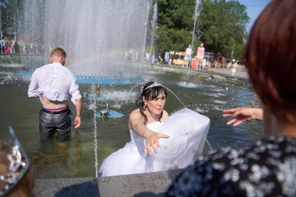 Жара. Жених и невеста стоят в фонтане.