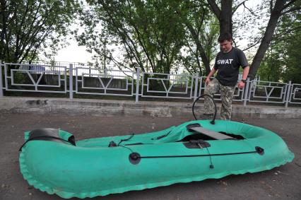 Корреспондент `Комсомолки` стал Робинзоном в Москве. На снимке: Олег Адамович надувает лодку.