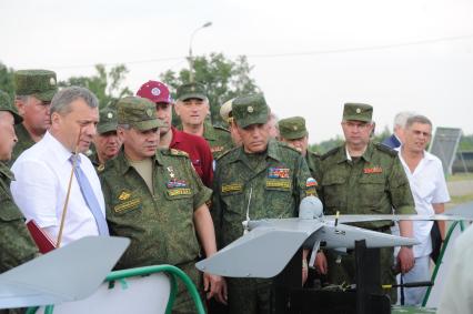 Учебно-тренировочный комплекс общевойскового полигона `Алабино`. Демонстрация комплексов беспилотных летательных аппаратов (БПЛА). На снимке: министр обороны РФ Сергей Шойгу (в центре) и начальник Генерального штаба ВС РФ, генерал армии Валерий Герасимов (второй справа).