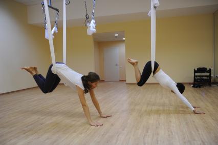 Антигравити Йога (AntiGravity Yoga). Телеведущая Ирина Шадрина (слева) в спортзале.