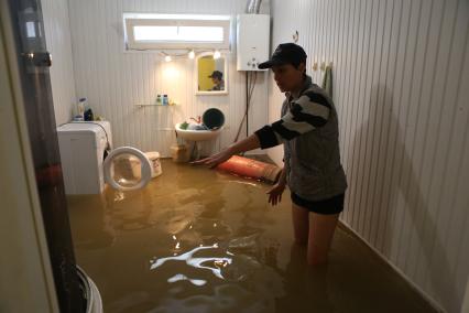 Наводнение в Сочи. На снимке: женщина в  затопленном водой жилом доме.