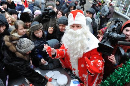 Стокилограммовый леденец в виде лошади, приготовленный тверскими кондитерами установлен на Площади Революции. На снимке: дети и взрослые дегустируют леденец.