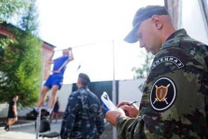 Спецназовец выполняет упражнения на турнике.