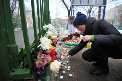 Возложение цветов к воротам Московской школы № 263, где вчера в результате стрельбы, совершенной старшеклассником Сергеем Гордеевым, погибли учитель и полицейский. На снимке: девочка ставит свечку.