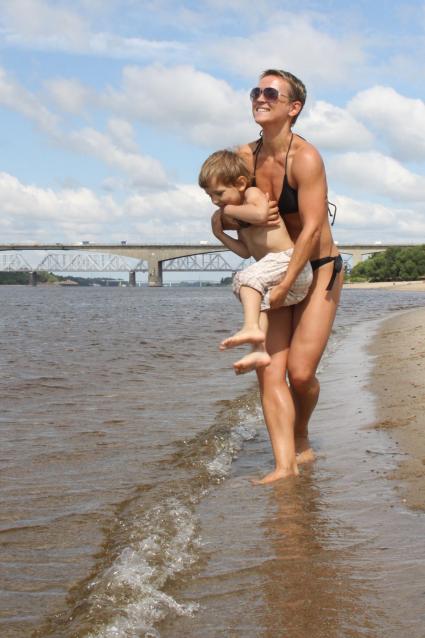 Женщина с ребенком на городском пляже.