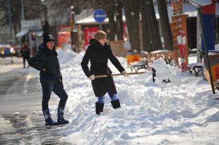 ВВЦ. ВДНХ. На снимке: девушка чистит снег.