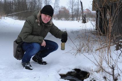 Молодой человек набрал воду в бутылку для проведения анализа.