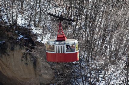 Кабинка с туристами на канатной дороге над Курортным парком Кисловодска зимой