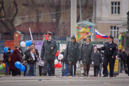 Полицейский и девушки-полицейские в курткахне по размеру после первомайского шествия