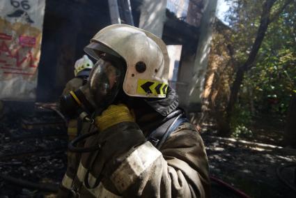 Пожарный в противогазе во время пожара в доме в Екатеринбурге