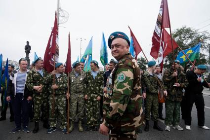 ветран ВДВ с голубом берете и тельняжке руководит построением десантником перед маршем в день ВДВ