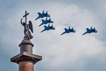 День российского флага в Санкт-Петербурге. Военные самолеты на фоне Александровской колонны на Дворцовой площади.