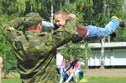 Учебный центр служебного собаководства в Дмитрове. Парад с участием 400 служебных собак, посвященный 90-ой годовщине образования. На снимке: военнослужащий с ребенком.